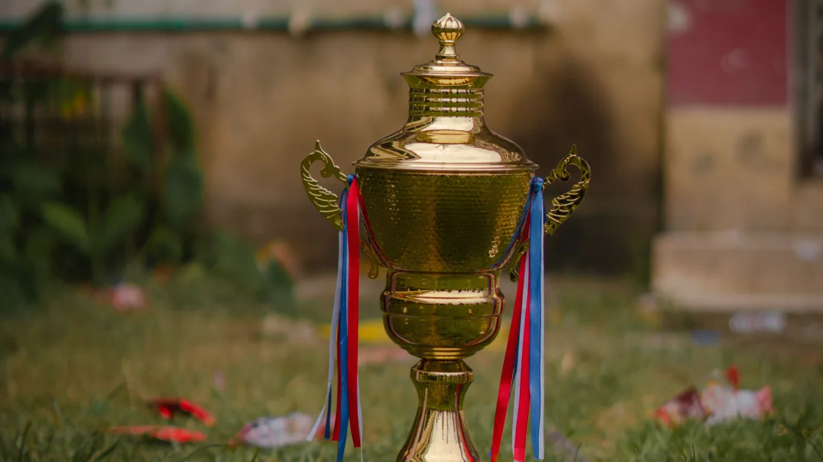 A cricket bat and ball on the pitch, the sport that gave the Ranji Trophy its name