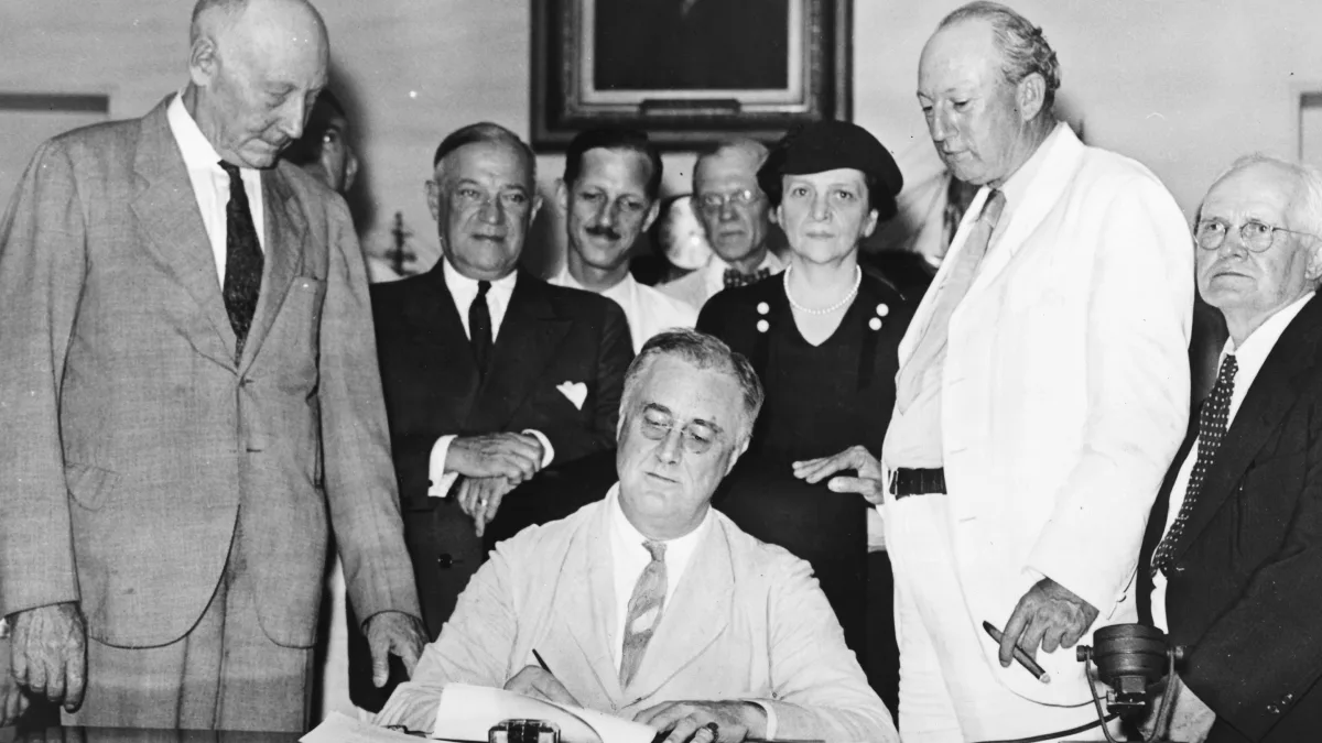 President Franklin D. Roosevelt signing the Social Security Act into law in 1935